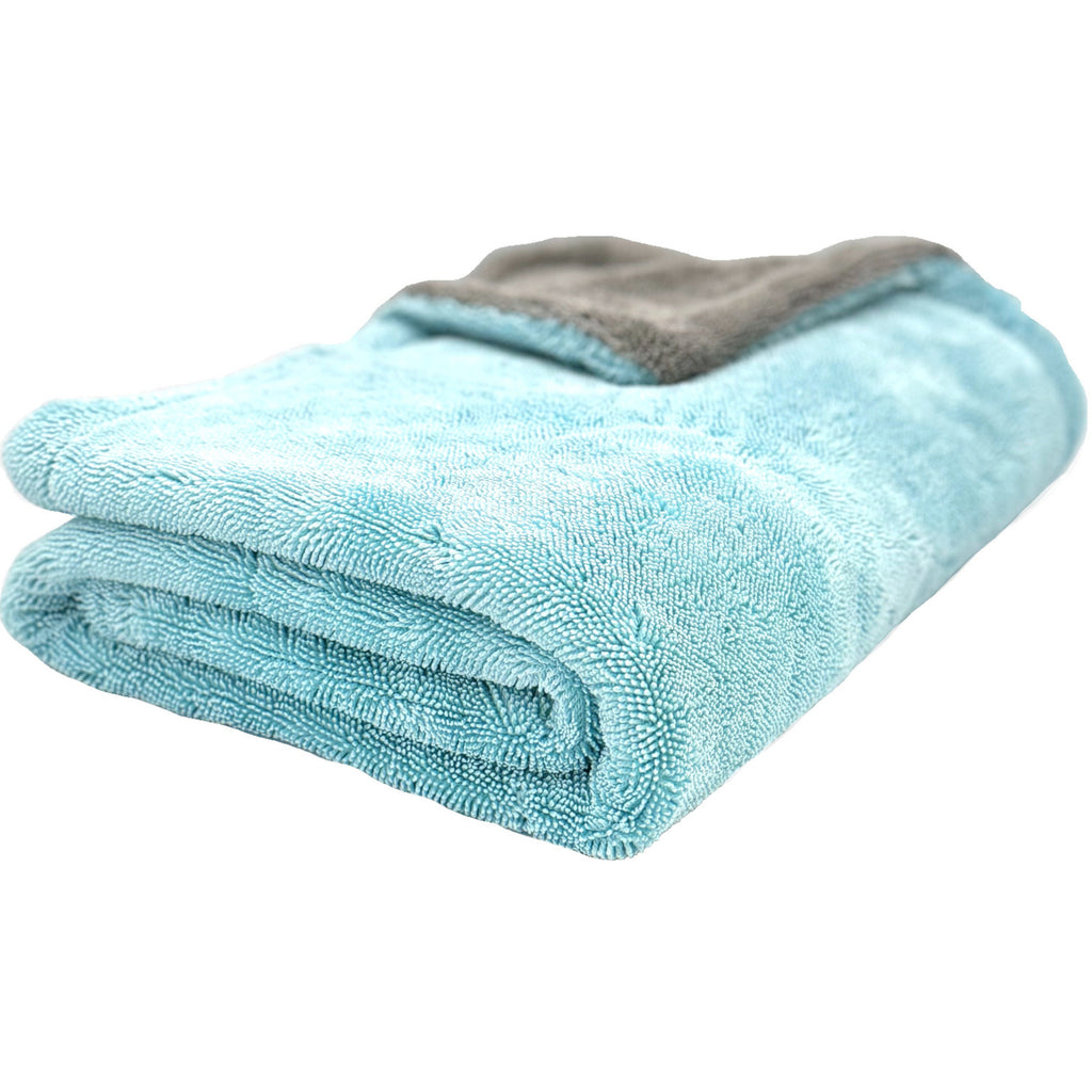 Blue microfiber towel folded neatly, showcasing its soft texture and absorbent material, ideal for cleaning and drying surfaces without leaving streaks or lint.